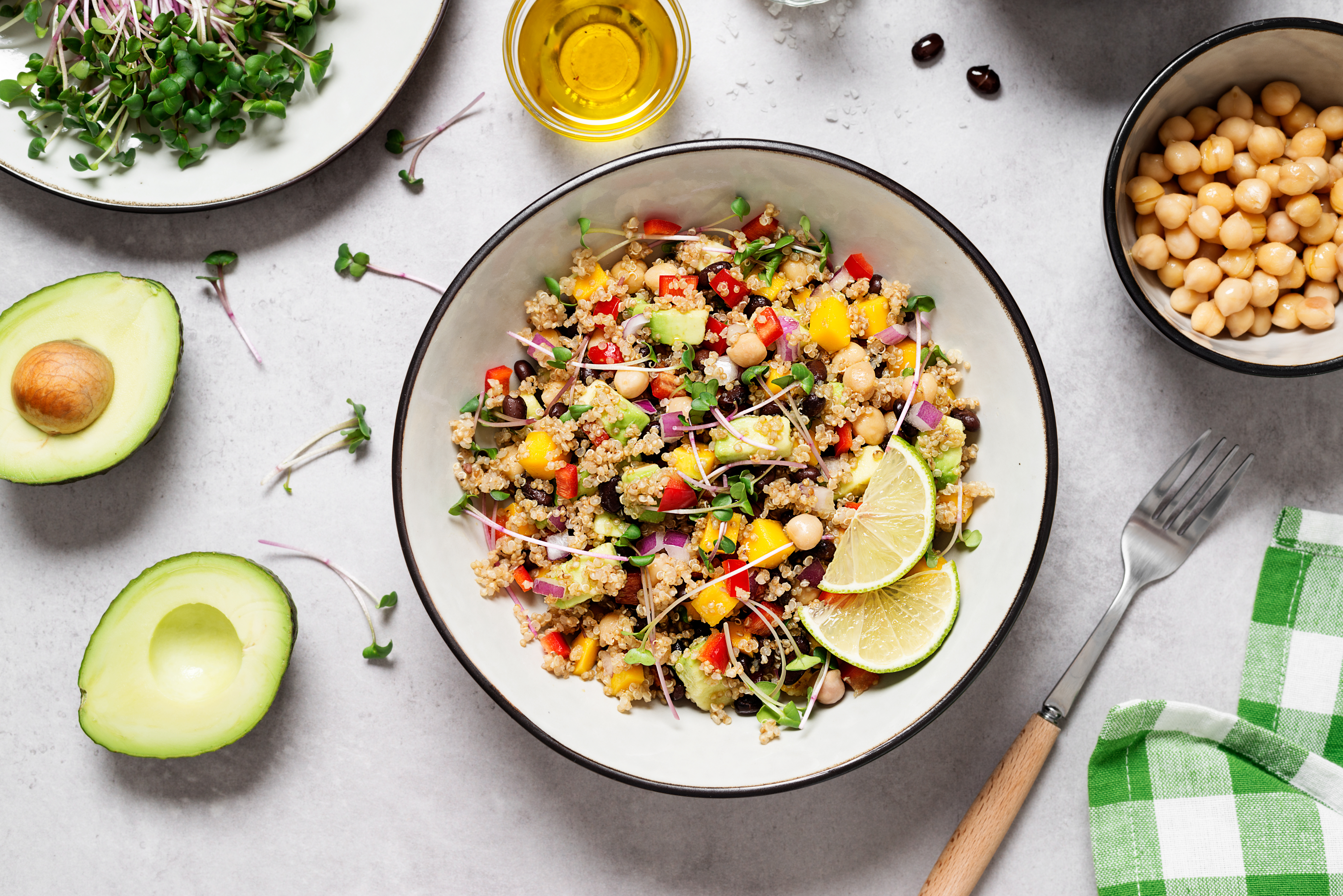 A bowl of quiona with fresh vegtables and fruits.